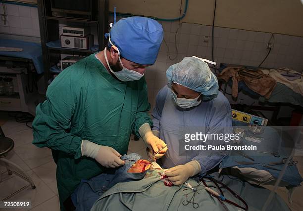 Doctor Olfat Hashimi works with nurse Nazia Loudin while operating on Sakima during an operation to fix her right cleft lip at a special clinic to...
