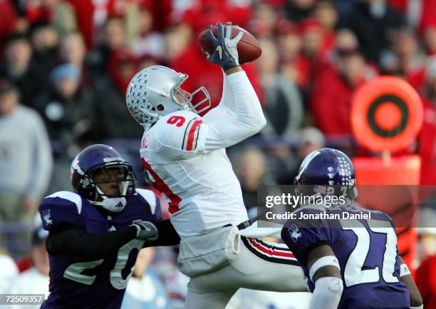 Brian Hartline of the Ohio State Buckeyes goes up to catch a pass in between defenders Marquice Cole and Reggie McPherson of the Northwestern...