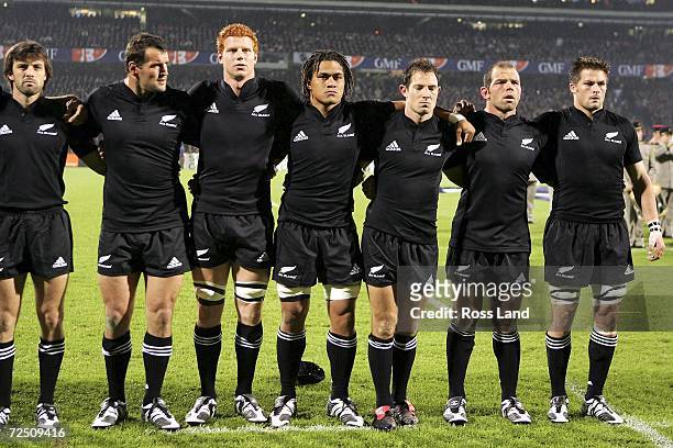 Conrad Smith, Carl Hayman, James Ryan, Rodney So'oialo, Leon Macdonald, Anton Oliver and Richie McCaw of New Zealand line up for the national anthems...