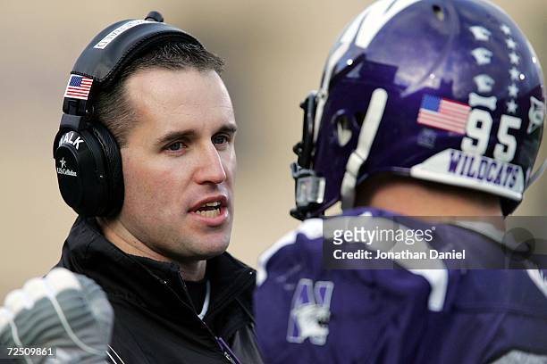 Head coach Pat Fitzgerald of the Northwestern Wildcats talks to Kevin Mims on the sidelines during a game against the Ohio State Buckeyes on November...