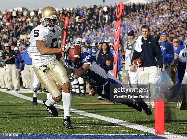 Wide receiver Rhema McKnight of the Notre Dame Fighting Irish eludes the grasp of Chris Sutton the Air Force Falcons for a touchdown in the first...