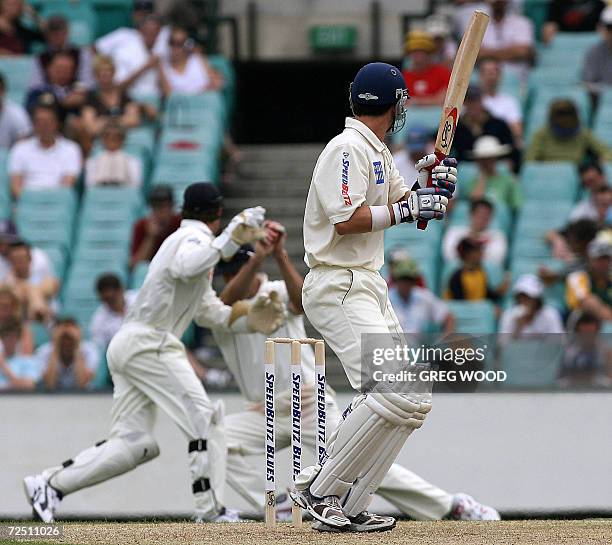 New South Wales batsman Aaron Obrien looks around to see England fieldsman Marcus Trescothick take a catch to dismiss him off the bowling of James...