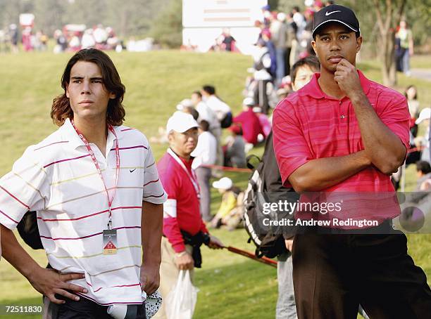 Tiger Woods of USA stands with Rafael Nadal, Spanish tennis star, on the 14th hole during the final round of The HSBC Champions tournament at The...