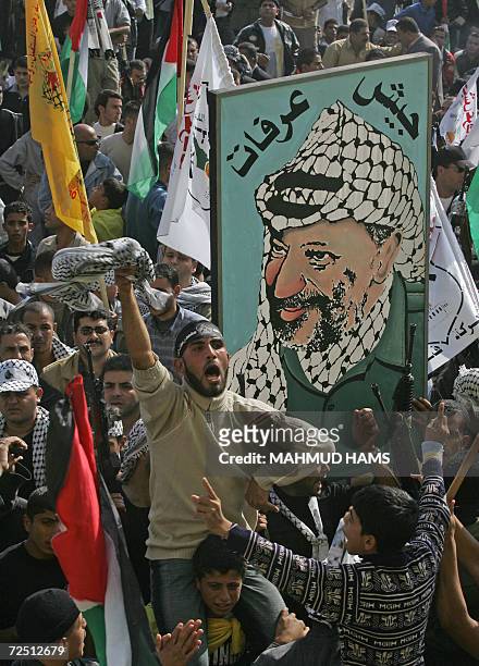 Palestinian Fatah supporters shout pro-Fatah slogans during a rally marking the second anniversary of the death of veteran Palestinian leader Yasser...