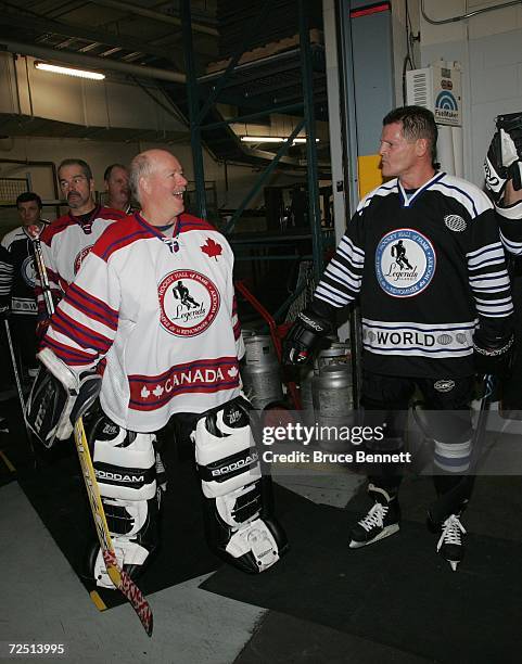 Goaltender Billy Smith of Team Canada and Chris Nilan of Team World joke prior to the Hockey Hall of Fame Legends Classic game at the Air Canada...