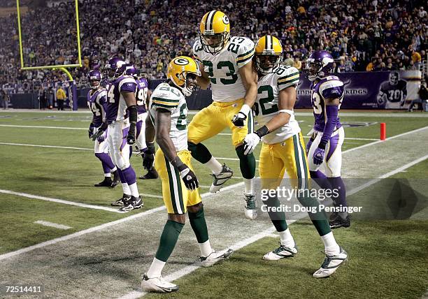 Donald Driver of the Green Bay Packers is congratulated by Noah Herron and Ruvell Martin after he gained 30 yards on a lateral from Greg Jennings...