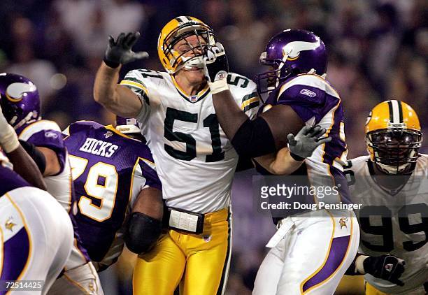 Brady Poppinga of the Green Bay Packers tries to get past Marcus Johnson of the Minnesota Vikings on November 12, 2006 at the Metrodome in...