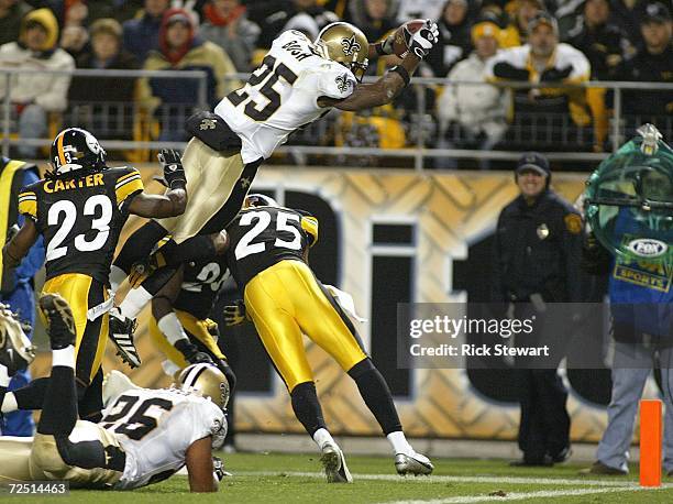 Reggie Bush of the New Orleans Saints jumps for the end zone to score a touchdown over Ryan Clark of the Pittsburgh Steelers on November 12, 2006 at...