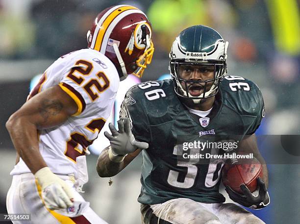 Running back Brian Westbrook of the Philadelphia Eagles looks to evade cornerback Carlos Rogers of the Washington Redskins on November 12, 2006 at...