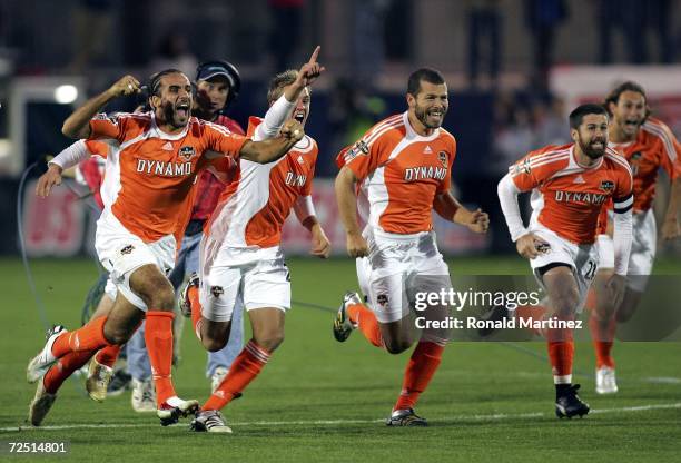 Dwayne DeRosario, Stuart Holden, Alejandro Moreno, Wade Barrett and Kelly Gray of the Houston Dynamo run to celebrate with teammate goaltender Pat...