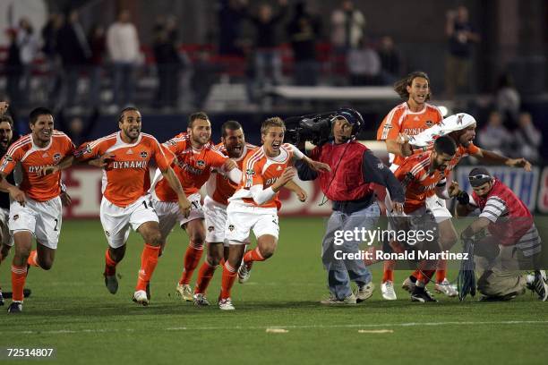 Brian Ching, Dwayne DeRosario, Stuart Holden, Alejandro Moreno, Wade Barrett, Kelly Gray and Paul Dalglish of the Houston Dynamo run to celebrate...