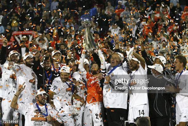 Captain Wade Barrett of the Houston Dynamo hoists the Alan I. Rothenberg Trophy after winning MLS Cup 2006 against the New England Revolution in...