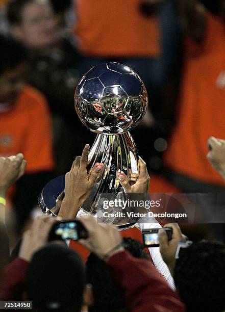 Member of the Houston Dynamo hoists the Alan I. Rothenberg Trophy after winning MLS Cup 2006 against the New England Revolution in penalty kicks 4-3...