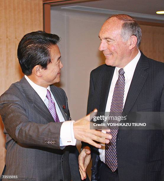 Visiting Australian Trade Minister Warren Truss is greeted by Japanese Foreign Minister Taro Aso prior to their talks at Aso's office in Tokyo, 13...