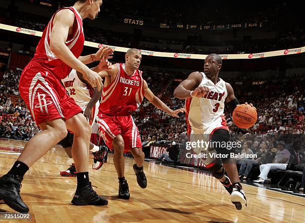 Dwyane Wade of the Miami Heat drives against Shane Battier and Yao Ming of the Houston Rockets on November 12, 2006 at American Airlines Arena in...