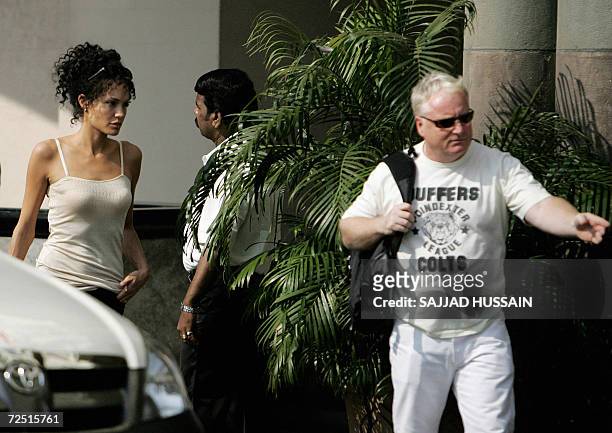 Actor Angelina Jolie is escorted by her bodyguard on location during a film shoot in Mumbai, 13 November 2006. Jolie is in Mumbai to shoot for her...