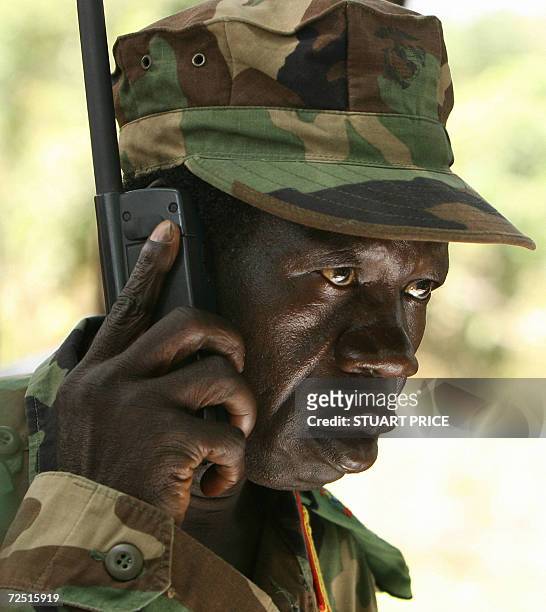 Lord's Resistance Army deputy commander Vincent Otti talks on a sattelite telephone 12 November 2006 before a meeting between the rebel group's...