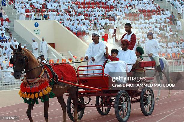 Omani athlete Mohammed bin Salim al-Rawahi carries the torch for the 2006 Asian Games as it passes through Muscat 13 November 2006. The Games, taking...