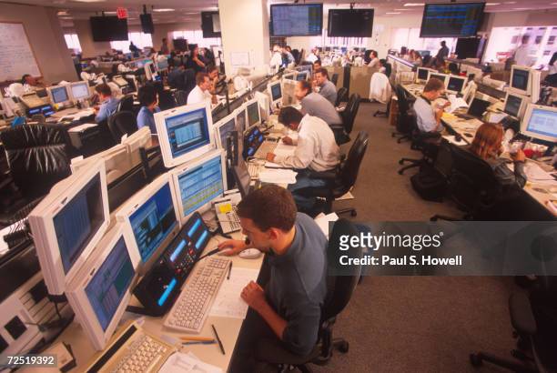 Brokers field calls on Enron's trading floor which trades and brokers packages of energy, making billions in the ptocess August 17, 2000 in Houston,...