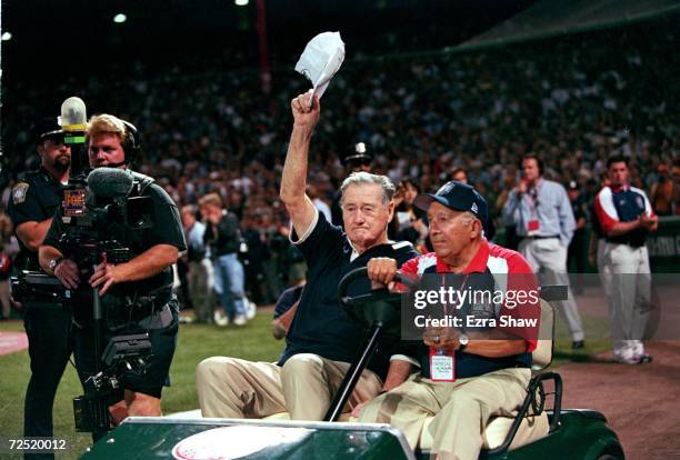 Ted Williams waves to the crowd as he is driven onto the field before the 1999 MLB All-Star Game against the National League Team and the American...