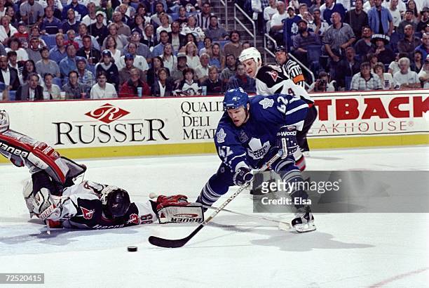 Kevyn Adams of the Toronto Maple Leafs controls the puck during the game against the Buffalo Sabres at the Marine Midland Arena in Buffalo, New York....