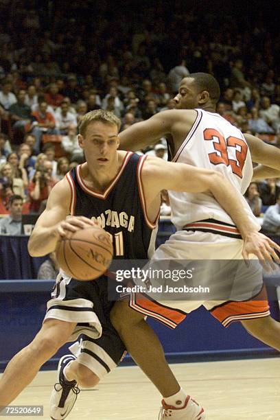 Matt Kincade of Gonzaga drives past Dion Edwards of Louisville during the first round of the Western Regional NCAA Tournament at the McKale Center in...