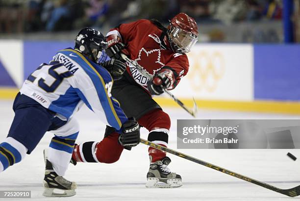 Vicky Sunohara of Canada shoots past Svetlana Vassina of Kazakhstan in the women's ice hockey preliminary round match between Canada and Kazakhstan...