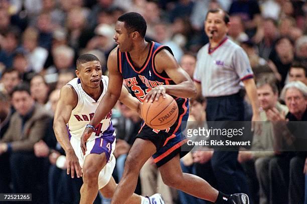 Charlie Ward of the New York Knicks moves with the ball around Muggsy Bogues of the Toronto Raptors during the NBA Eastern Conference Round One Game...