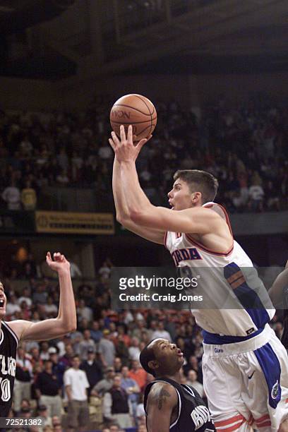 Forward Mike Miller of the Florida Gators launches the game winning shot to lead Florida to a 69-68 overtime win over the Butler Bulldogs during...