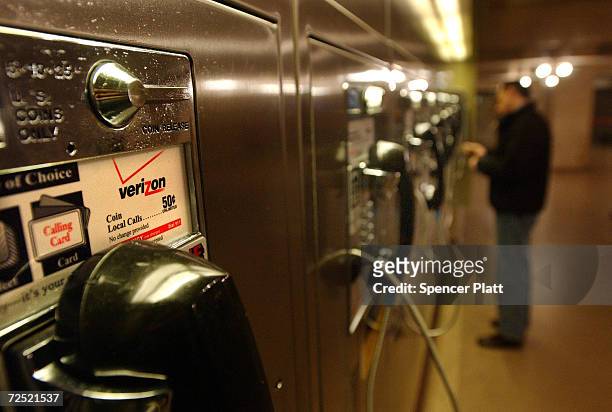 Man makes a phone call from a Verizon pay phone March 12, 2002 at Grand Central Station in New York City. Verizon has begun switching all of its New...