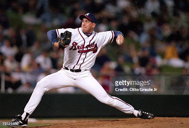 Pitcher John Rocker of the Atlanta Braves winds back to pitch the ball during a Spring Training Game against the Detroit Tigers at Disney Wide World...