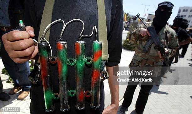 Masked Palestinian militants from the Al Aqsa martyrs brigade, a group affiliated with Yasser Arafat's Fatah movement, is seen dressed as a suicide...