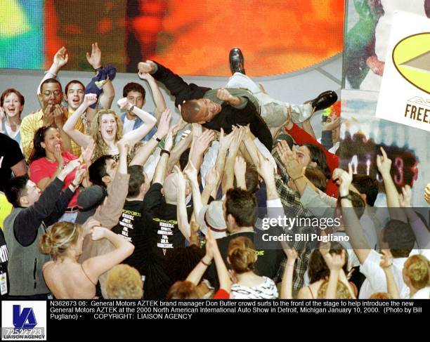 General Motors AZTEK brand manager Don Butler crowd surfs to the front of the stage to help introduce the new General Motors AZTEK at the 2000 North...