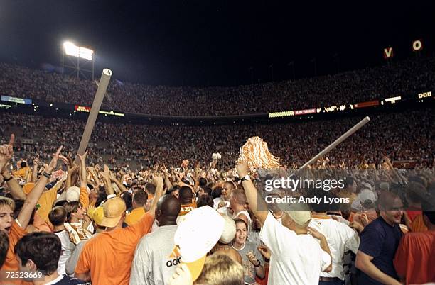 The fans rush on the field and take down the goal posts after the Tennesse Volunteers defeated the Florida Gators 20-17 at Neyland Stadium in...