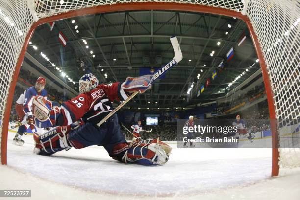 Mike Richter of the USA makes a save with Alexei Yashin of Russia to his left during the men's semifinals at the Salt Lake City Winter Olympic Games...