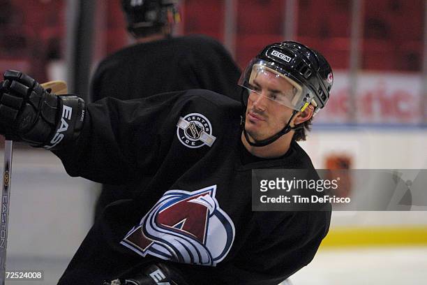 Forward Joe Sakic of the Colorado Avalanche takes a break during the morning practice of training camp during the 2001 NHL Challenge Series at the...