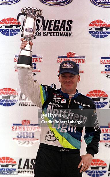 Jeff Burton holds his trophy aloft after winning the Busch Grand National Sam''s Town 300 at Las Vegas Motorspeedway in Las Vegas, Nevada.