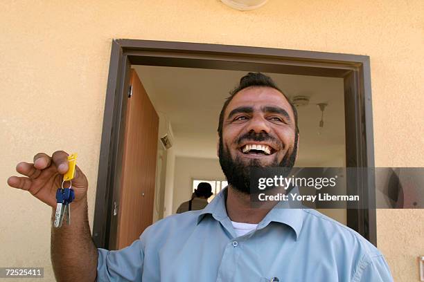 Yossi Ben Dahan holds the key for his new home in the newly-built community of mobile homes in Nitzan, north of the city of Ashkelon, in southern...