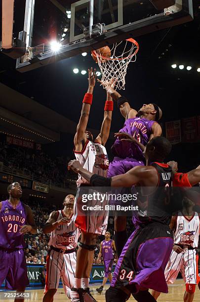 Jerome Williams of the Toronto Raptors at the basket against Eddie Griffin of the Houston Rockets during their game at Compaq Center in Houston,...