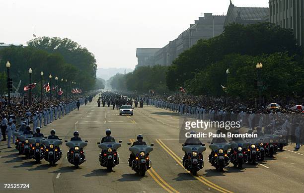 Capitol Police on motorcycles lead the horse drawn procession as it makes its way down Constitution Avenue enroute to the Capitol June 9, 2004 in...