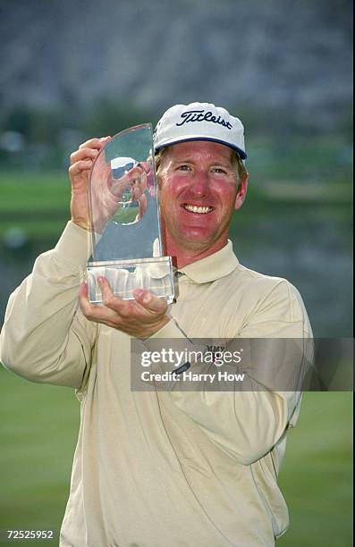 David Duval poses with the winners trophy during the Bob Hope Chrysler Classic at the PGA West Palmer Country Club in La Quinta, California....