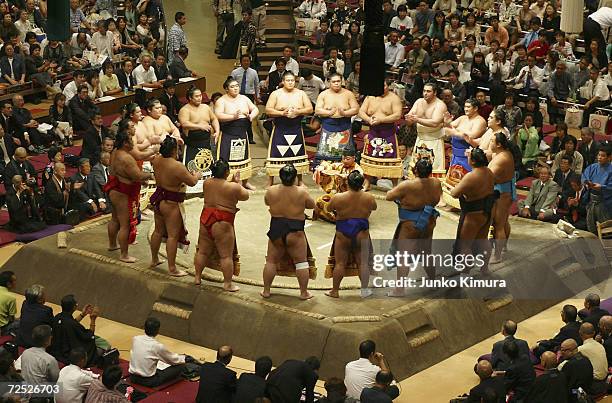 Sumo wrestlers conduct a ceremony prior to playing matches during the topknot cutting ceremony for Hawaiian-born former grand champion, or yokozuna,...