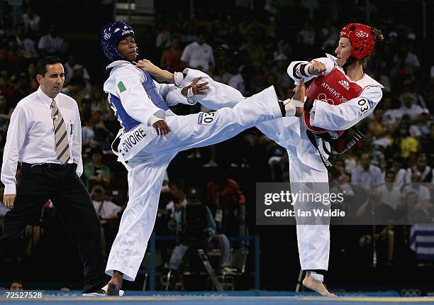 Miriam Bah of the Ivory Coast and Sonia Reyes of Spain kick each other in the women's under 57 kg Taekwondo repechage match on August 27, 2004 during...