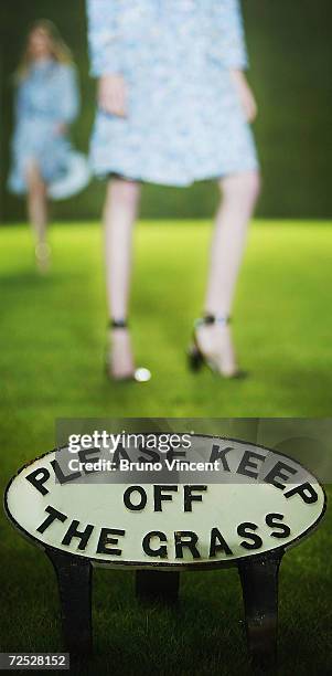 Sign that reads "Please Keep Off The Grass" is seen during the Paul Smith Women fashion show as part of London Fashion Week Spring/Summer 2005 at the...