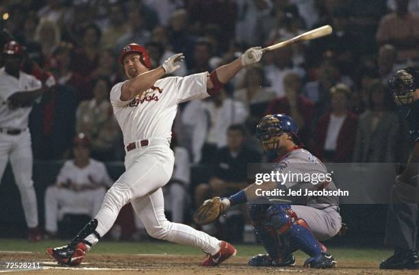 Mark McGwire of the St. Louis Cardinals hits his 62nd home run during the game against the Chicago Cubs at the Busch Stadium in St. Louis, Missouri....