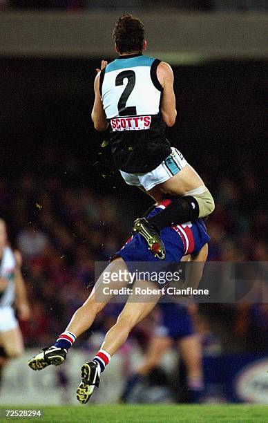 Darryl Wakelin for Port Adelaide takes a mark from Simon Garlick for the Bulldogs during the round 21 AFL match played between the Western Bulldogs...
