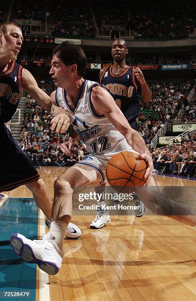 Point guard John Stockton of the Utah Jazz drives past forward Chris Andersen of the Denver Nuggets during the NBA game at the Delta Center in Salt...