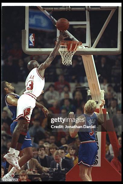 Guard Michael Jordan of the Chicago Bulls goes for two during a game against the Cleveland Cavaliers at the United Center in Chicago, Illinois....