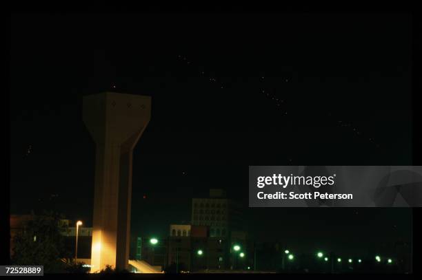 Anti-aircraft gunfire lights up the sky as Iraqi forces respond to December 20, 1998 missile strikes by American and British forces in Baghdad, Iraq....