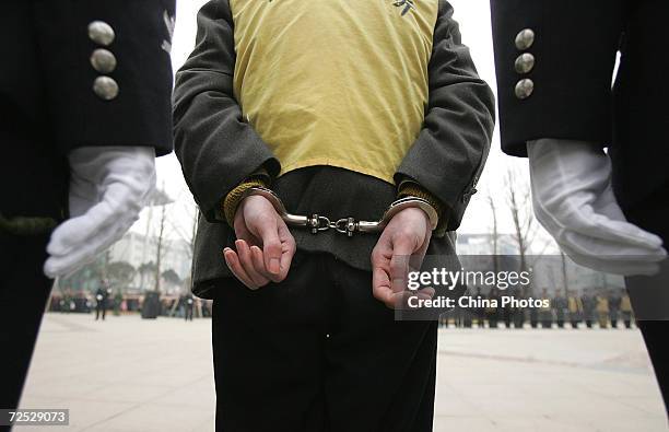 Police parade convicted criminals during a public sentence at a railway station on January 25, 2005 in Chengdu of Sichuan Province, China. The local...